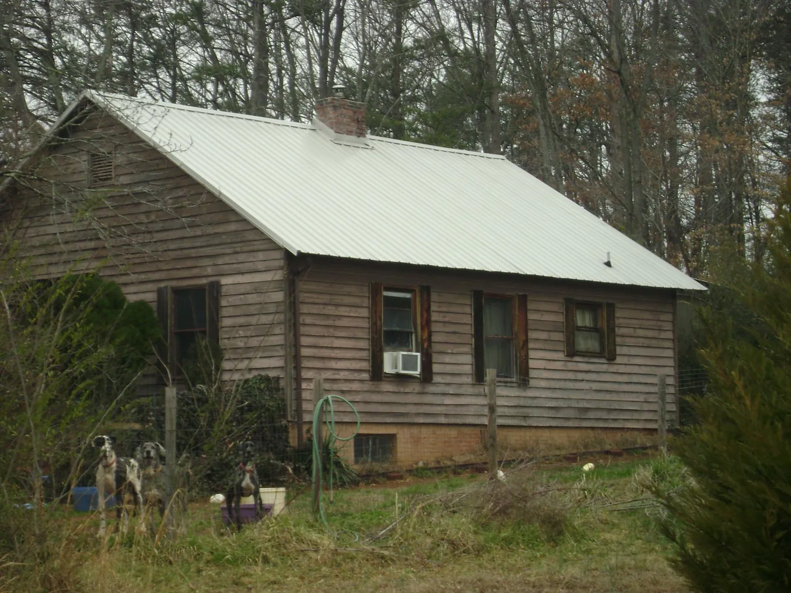 White metal roof on an old wood sided farmhouse, from a Metal Roof Installation job in Blair